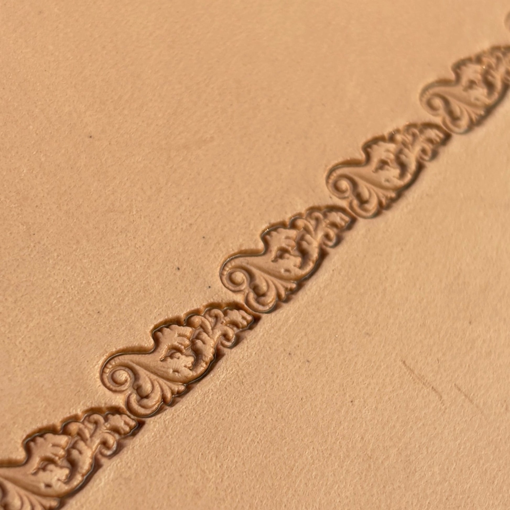 Scroll Border leather stamp LT331 — brass stamping tool with imprint on natural veg-tan leather
