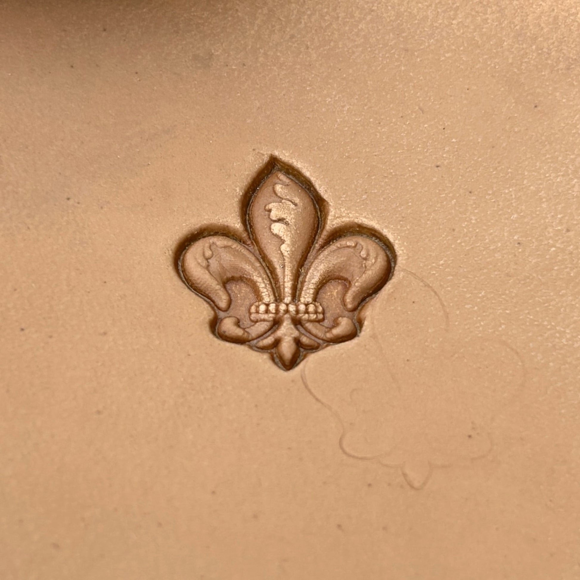 Fleur leather stamp LT332 — single impression on veg-tan leather