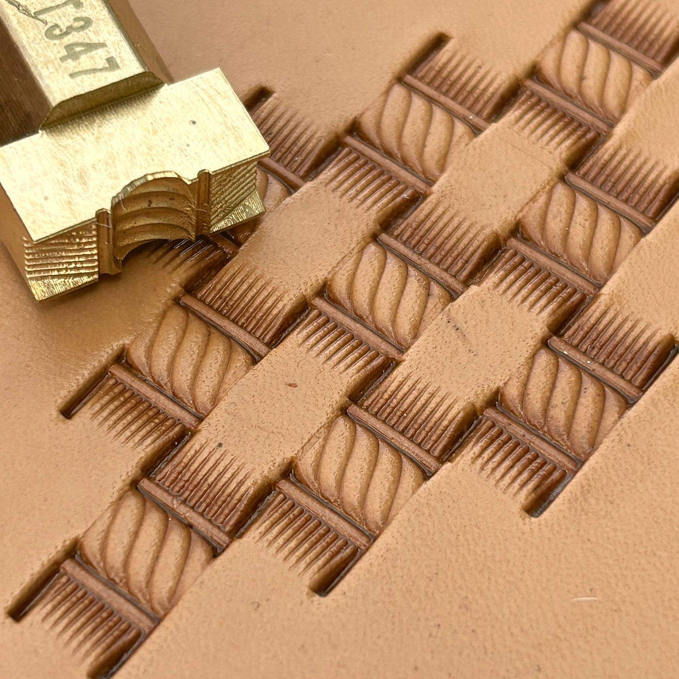 A basketweave pattern struck across tan leather.