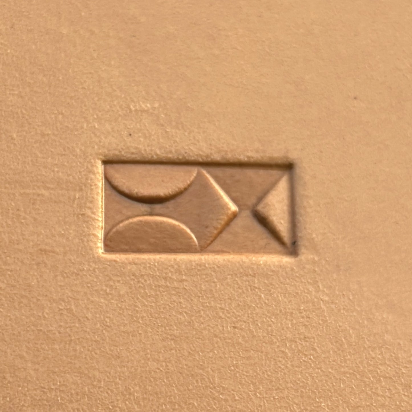 Geometric leather stamp LT360 — single impression on veg-tan leather
