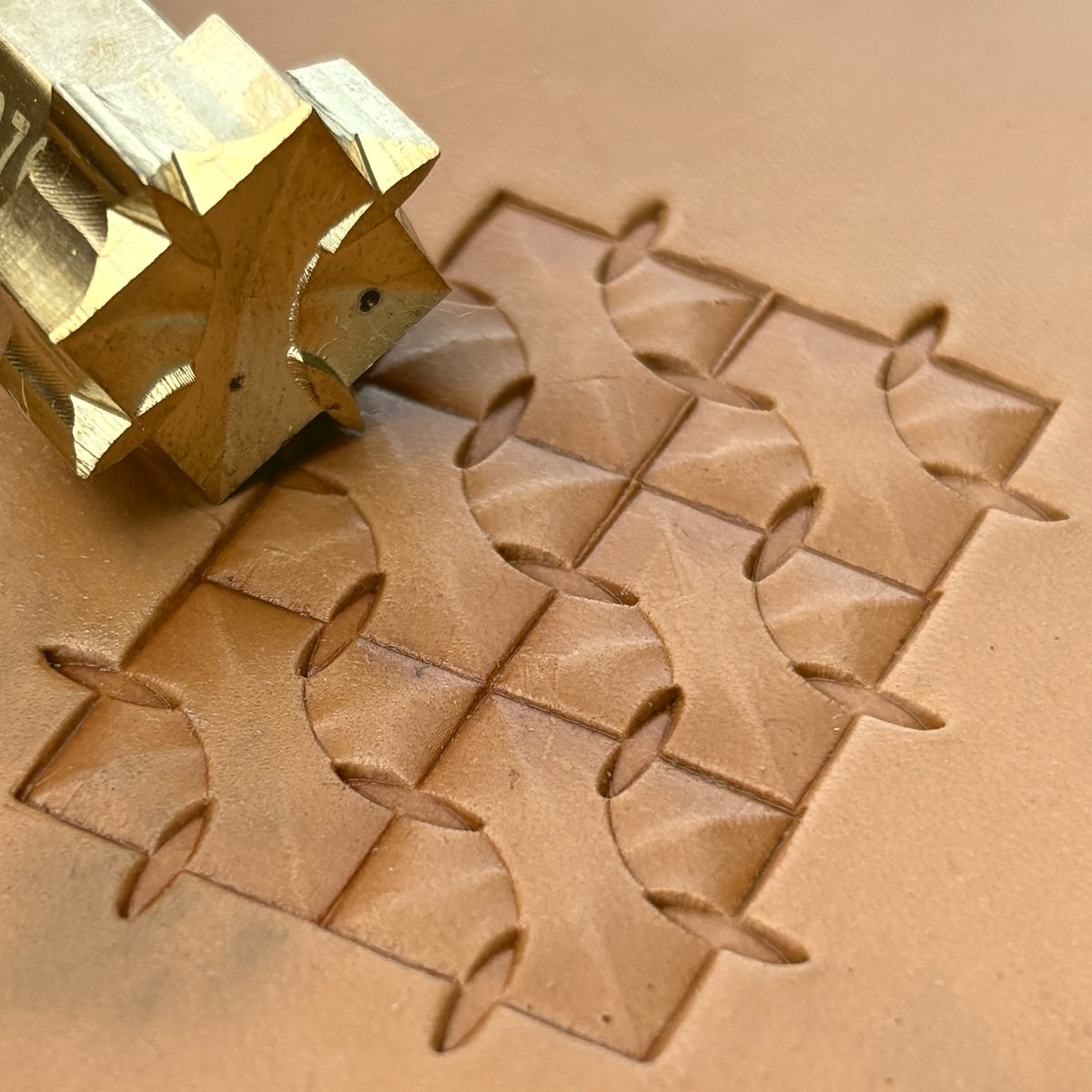Interlock Geometric leather stamp LT376 — brass stamping tool with imprint on natural veg-tan leather