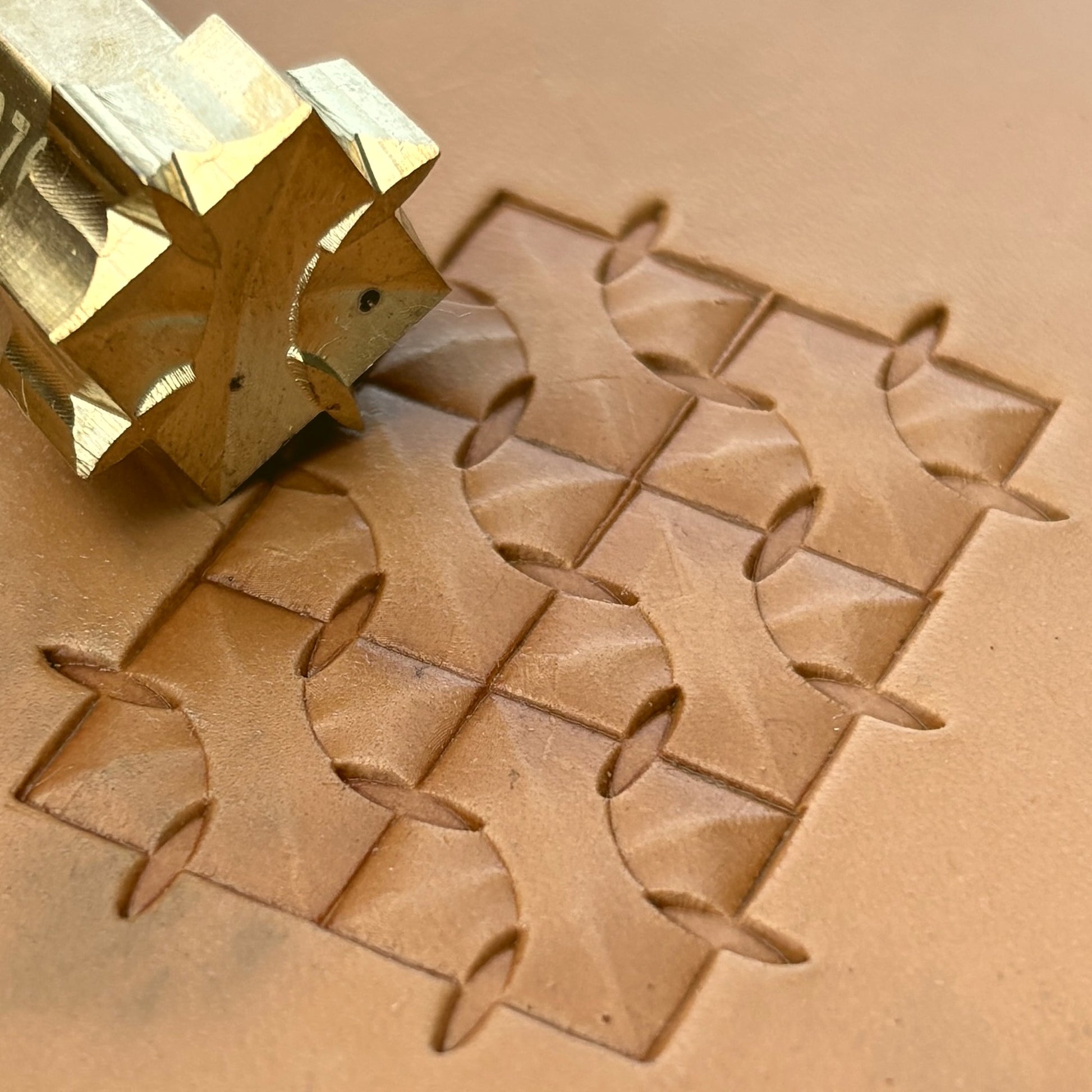 Interlock Geometric leather stamp LT376 — brass stamping tool with imprint on natural veg-tan leather