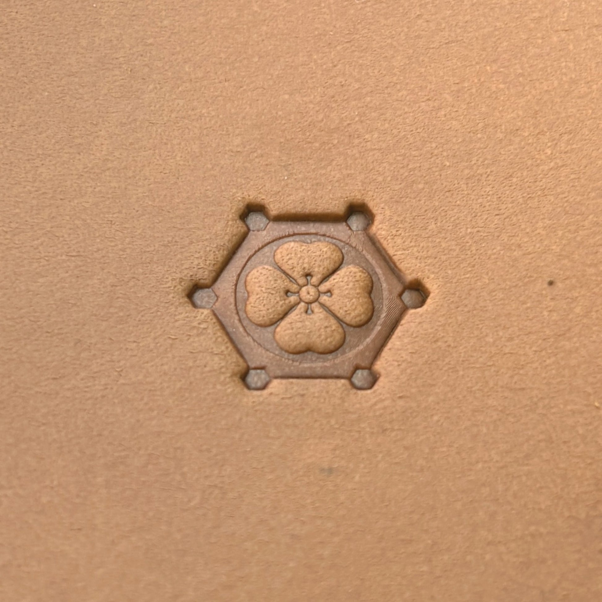 Floral Hexagon leather stamp LT377 — single impression on veg-tan leather
