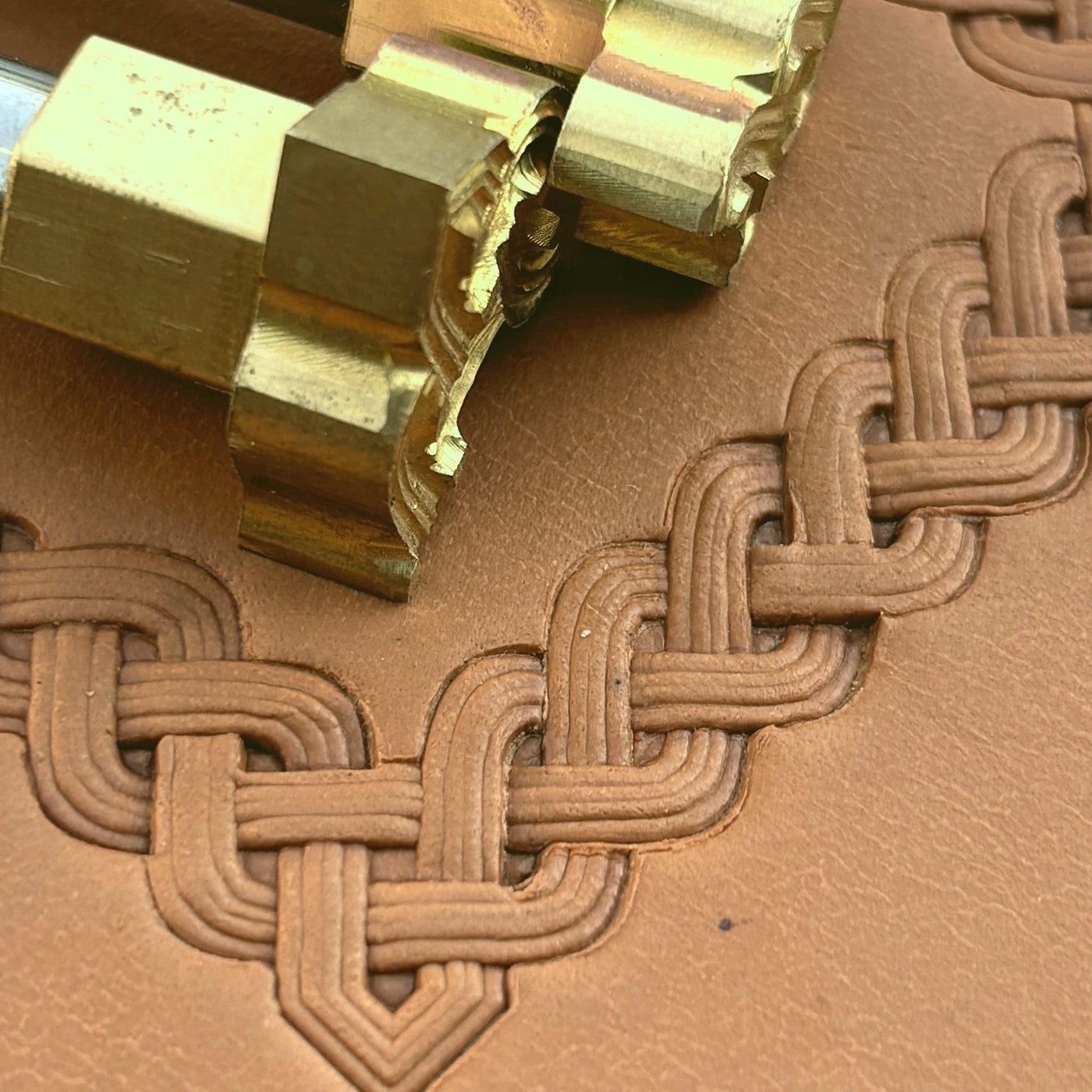 An interlaced Celtic knot stamped into leather.