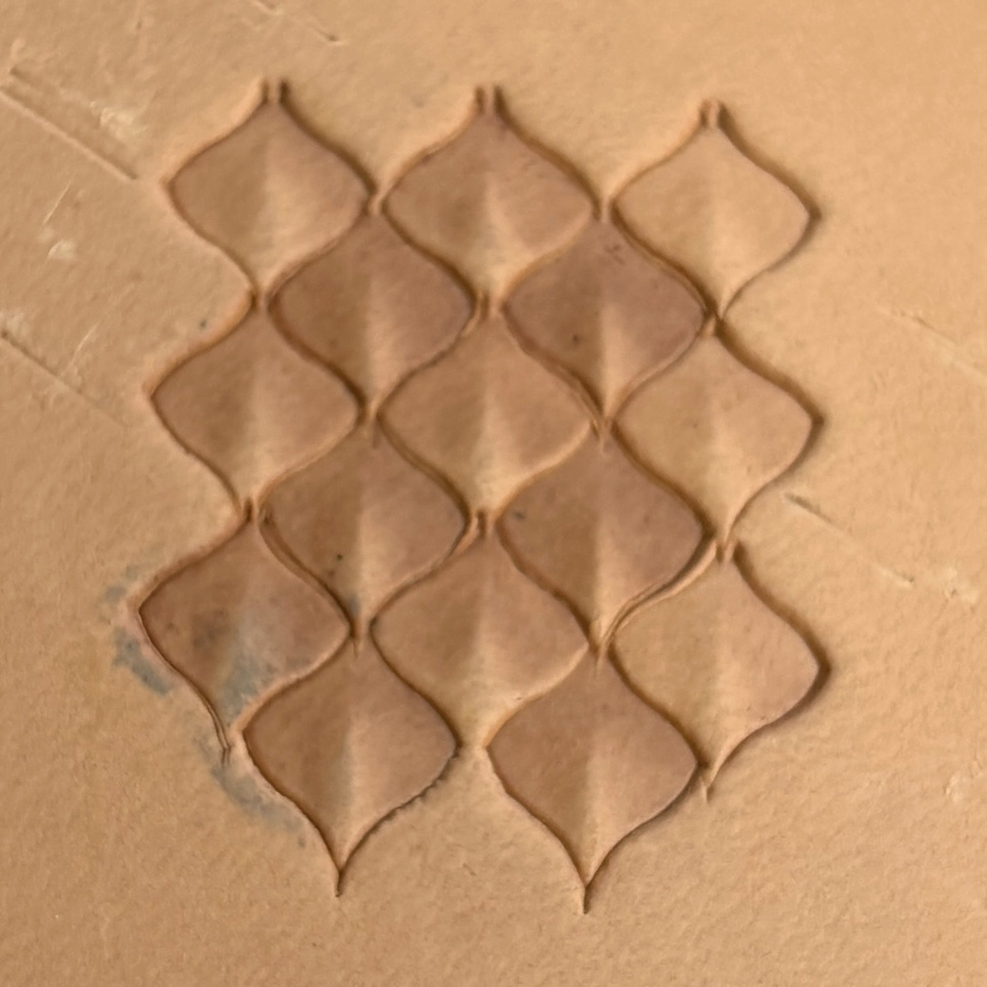 Diamond Grid leather stamp LT401 — single impression on veg-tan leather