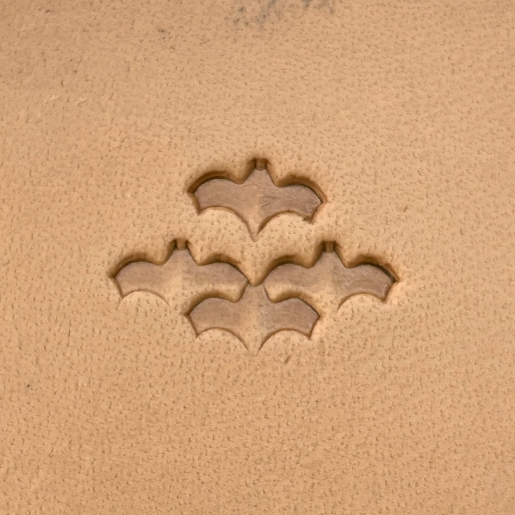 Scale Motif Bat leather stamp LT413 — single impression on veg-tan leather