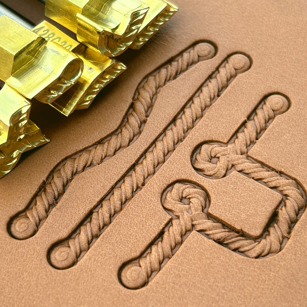 Coiled-End Rope leather stamp set LT428, brass stamps shown with their impressions on leather