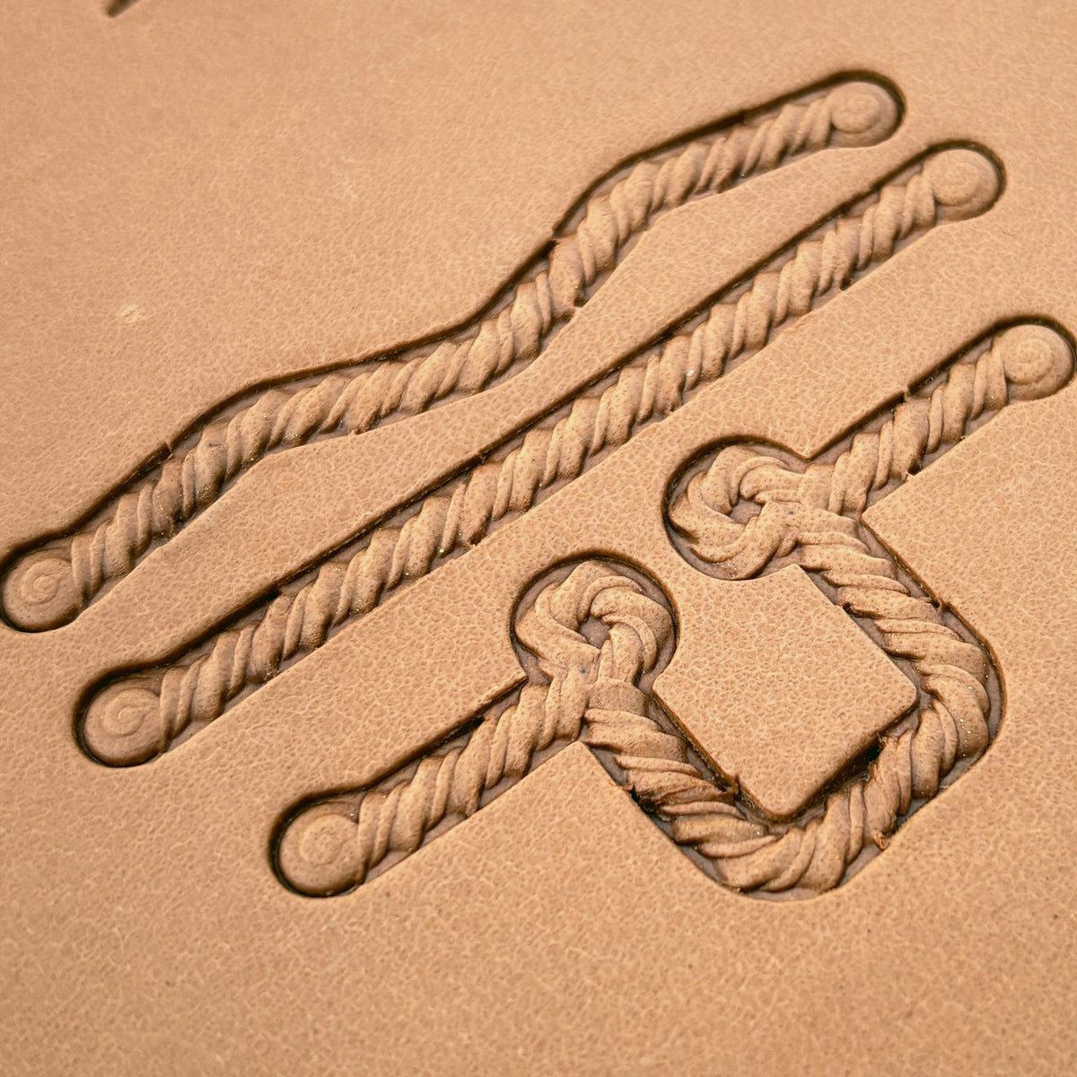 Coiled-End Rope leather stamp set LT428, straight runs, corners and ends combined into a border on leather