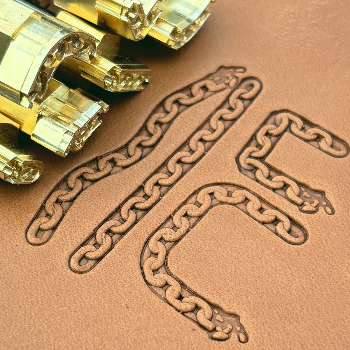 Oval Link Chain leather stamp set LT432, brass stamps shown with their impressions on leather