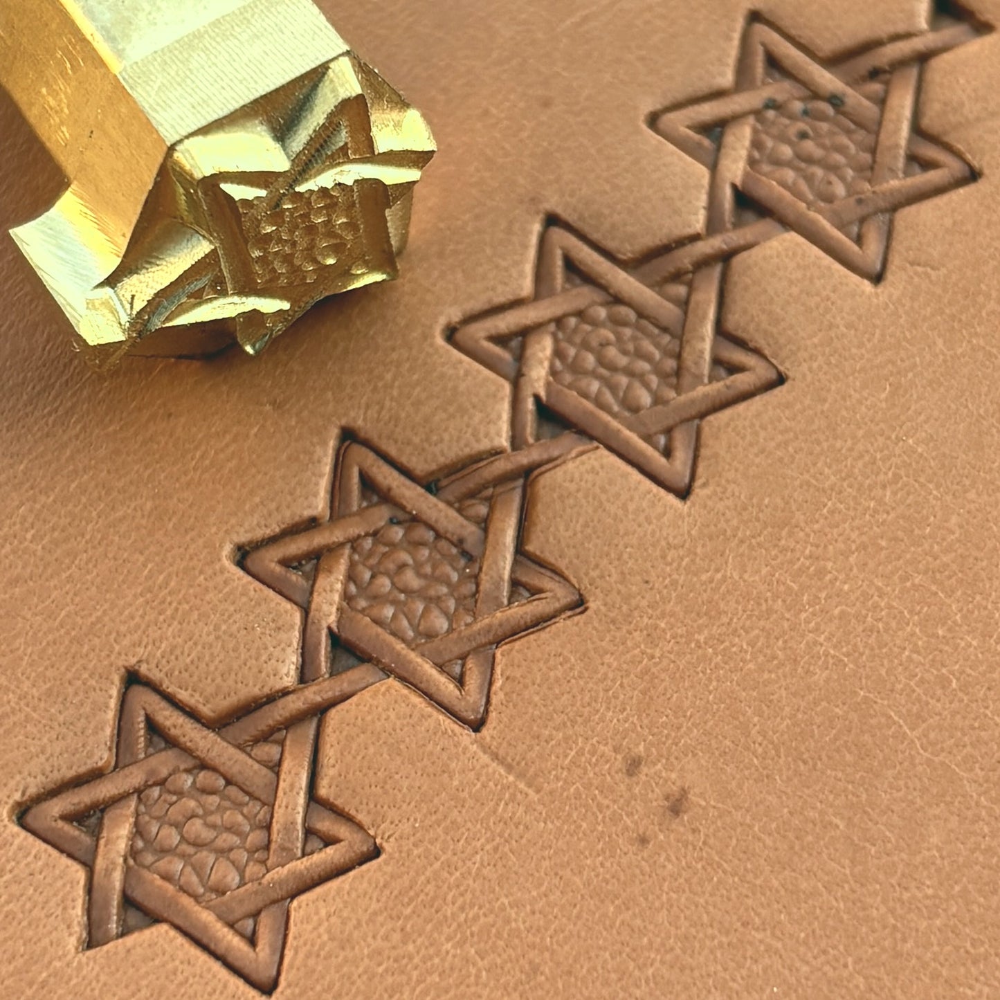 Interwoven Star Geometric leather stamp LT515 — brass stamping tool with imprint on natural veg-tan leather