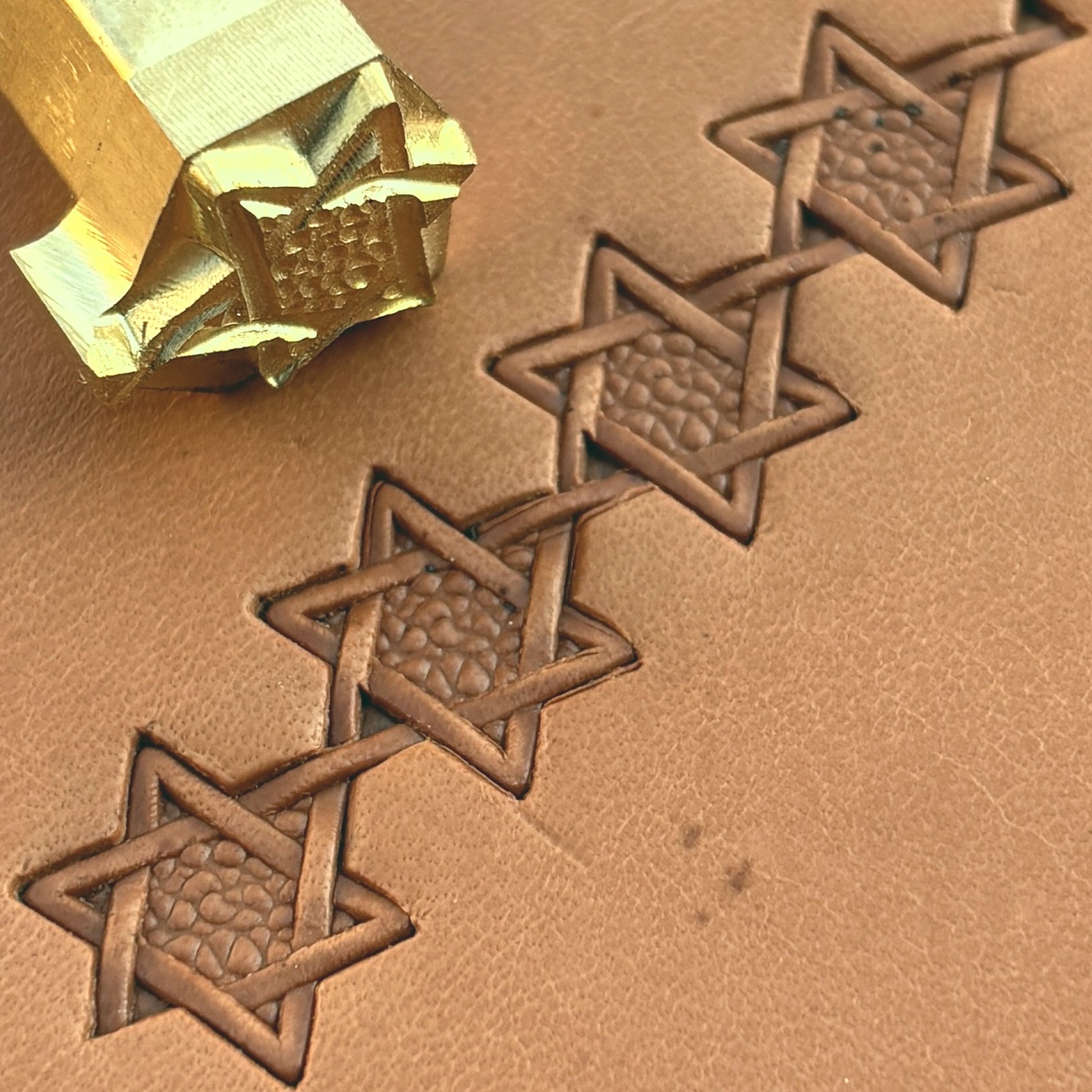 Interwoven Star Geometric leather stamp LT515 — brass stamping tool with imprint on natural veg-tan leather