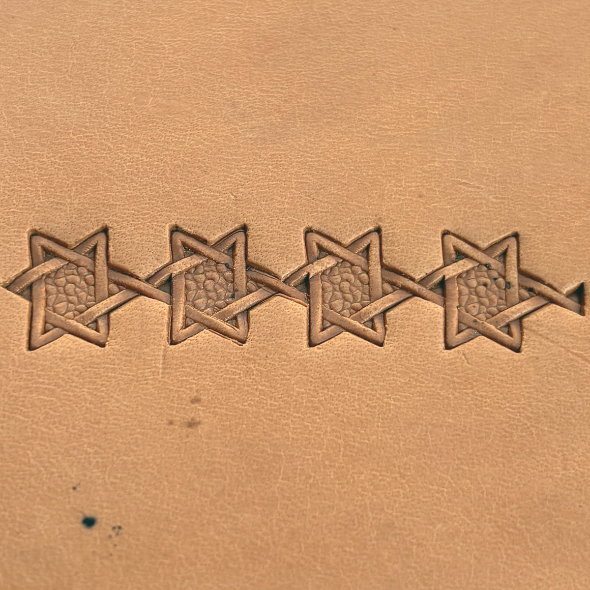 Interwoven Star Geometric leather stamp LT515 — pattern imprint on veg-tan leather