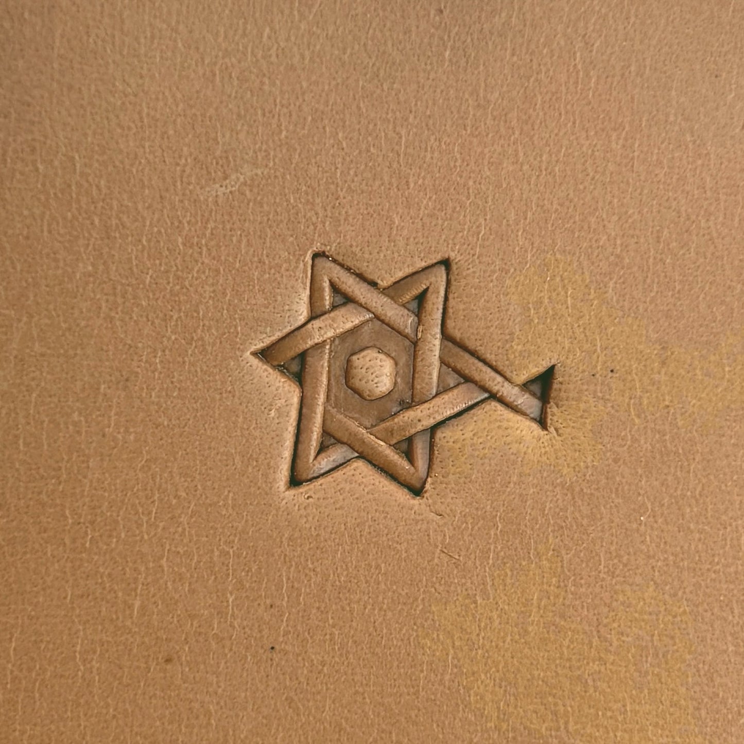 Interlocking Stars Geometric leather stamp LT516 — single impression on veg-tan leather