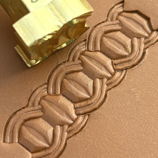 Interlock Geometric leather stamp LT525 — brass stamping tool with imprint on natural veg-tan leather