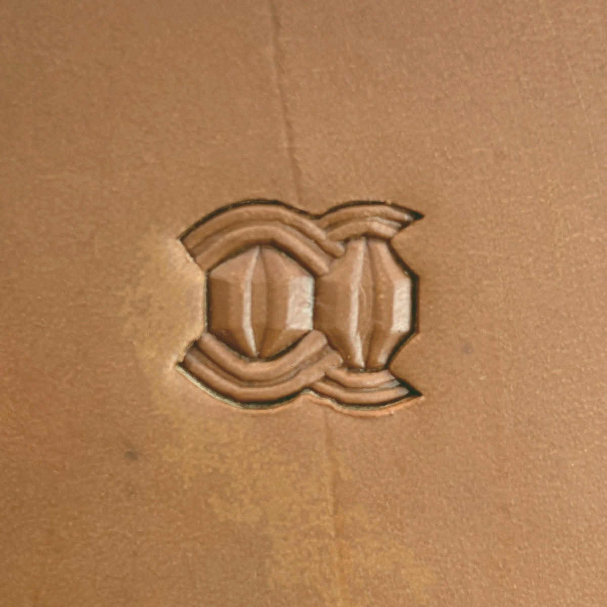 Interlock Geometric leather stamp LT525 — single impression on veg-tan leather