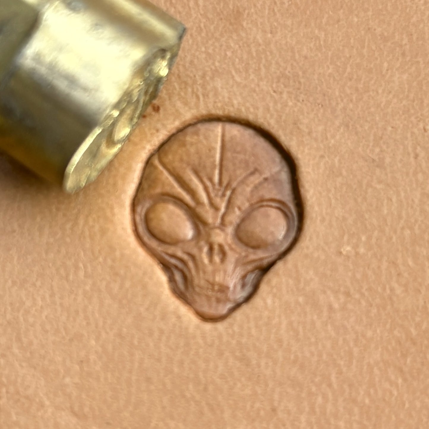 Alien Head Skull leather stamp LT569 — brass stamping tool with imprint on natural veg-tan leather