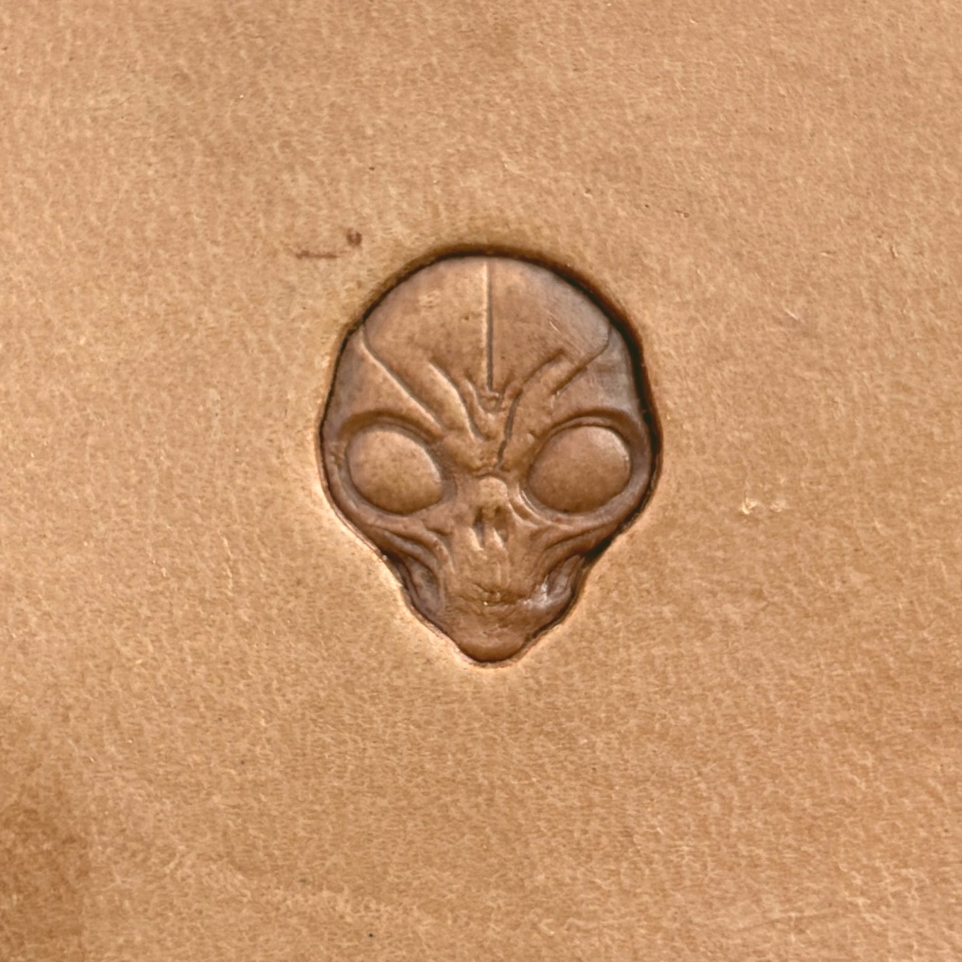 Alien Head Skull leather stamp LT569 — single impression on veg-tan leather