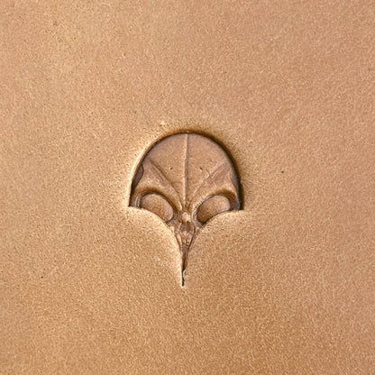 Alien Head leather stamp LT570 — single impression on veg-tan leather