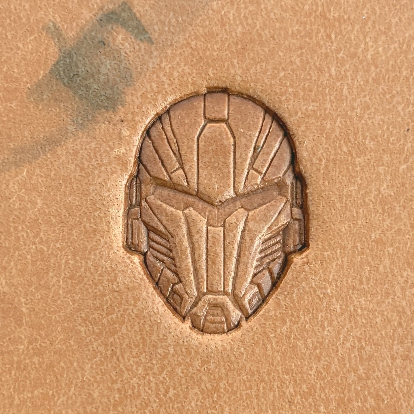 Futuristic Mask leather stamp LT588 — single impression on veg-tan leather