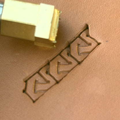 Interlock Geometric leather stamp LT593 — brass stamping tool with imprint on natural veg-tan leather