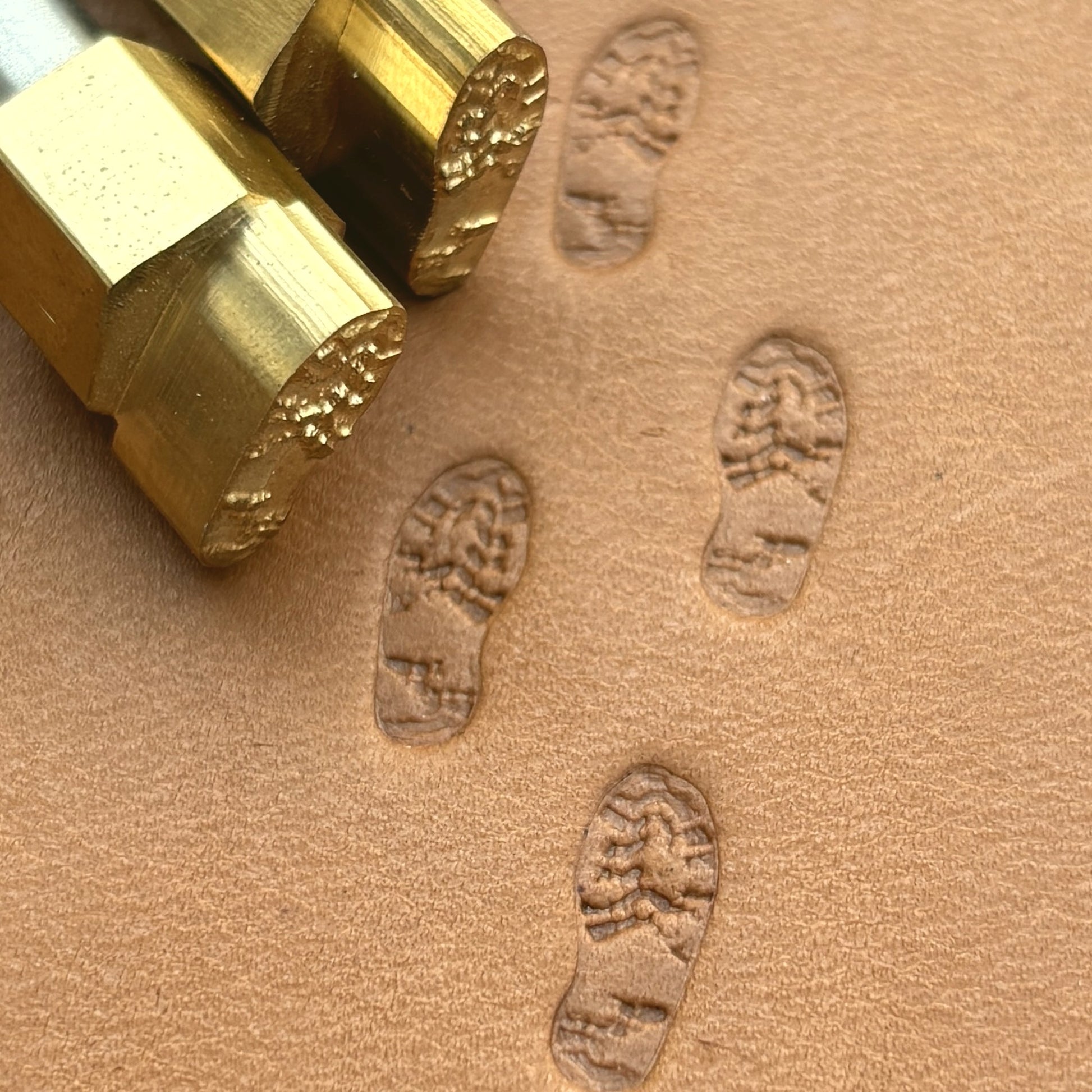 Trail Steps Footprint leather stamp LT604 — brass stamping tool with imprint on natural veg-tan leather