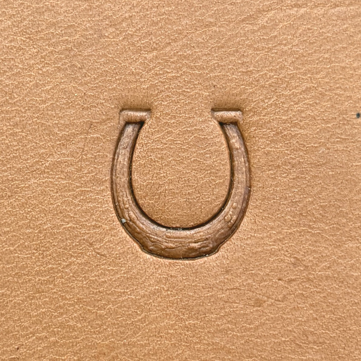 Horseshoe leather stamp LT614 — single impression on veg-tan leather