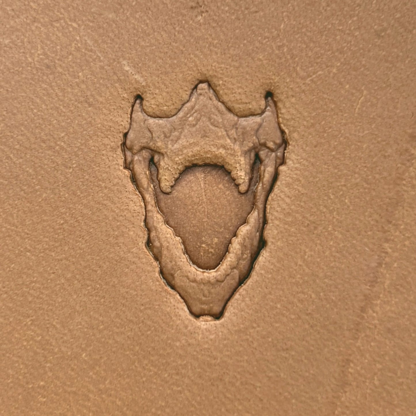 Open Jaws Skull leather stamp LT615 — single impression on veg-tan leather