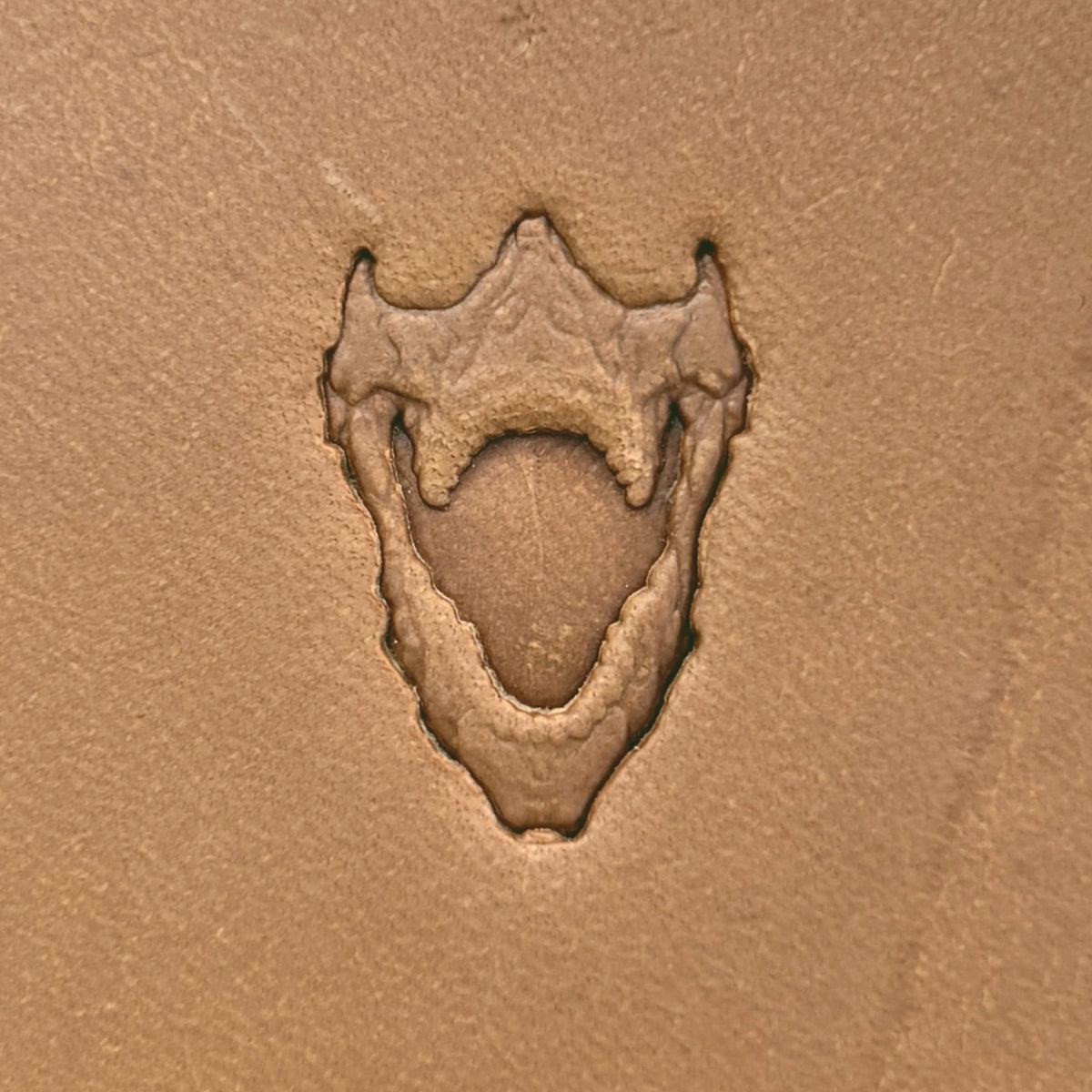 Open Jaws Skull leather stamp LT615 — single impression on veg-tan leather