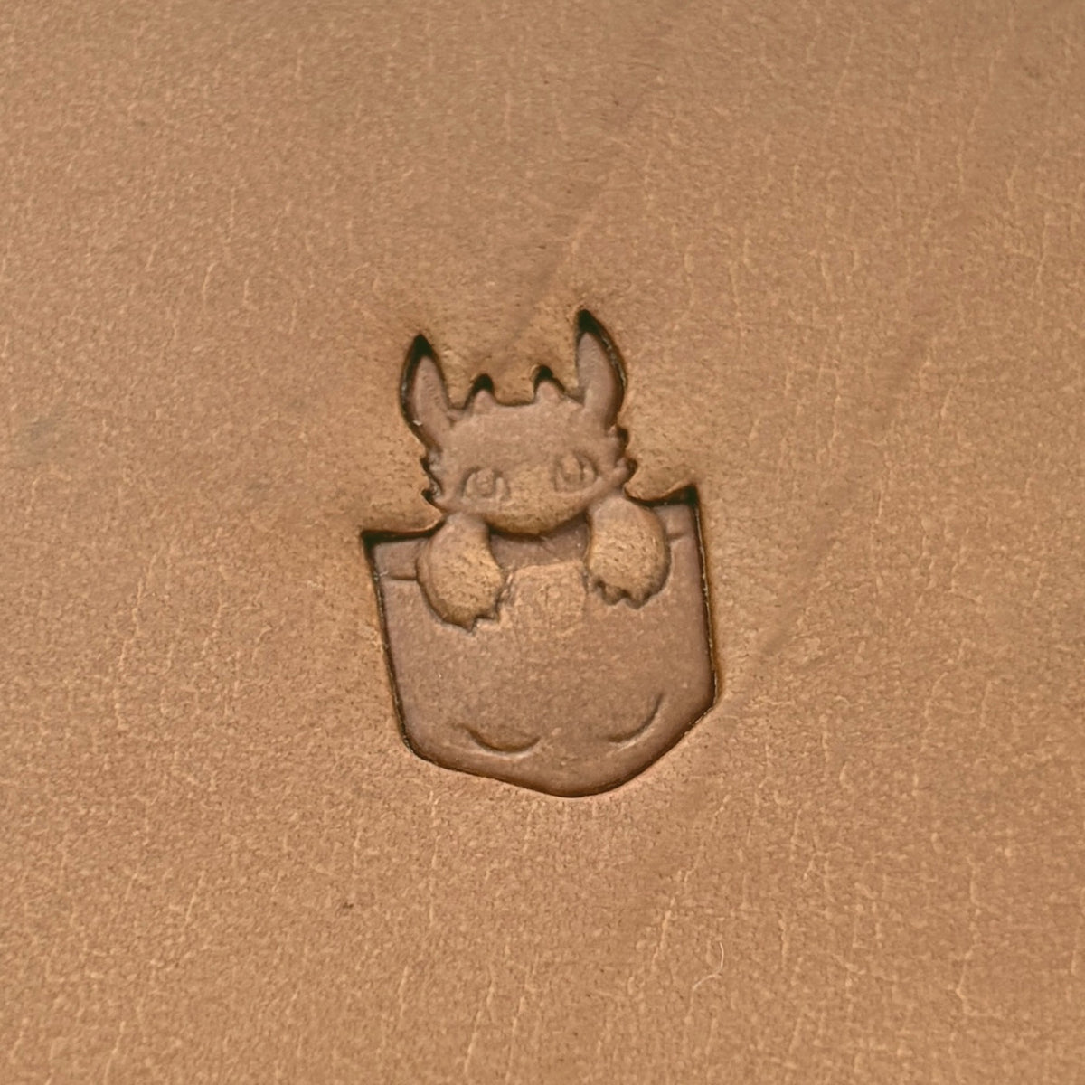 Pocket Dragon leather stamp LT619 — single impression on veg-tan leather