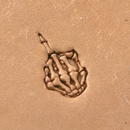 Middle Finger Skeleton Hand leather stamp LT634 — single impression on veg-tan leather