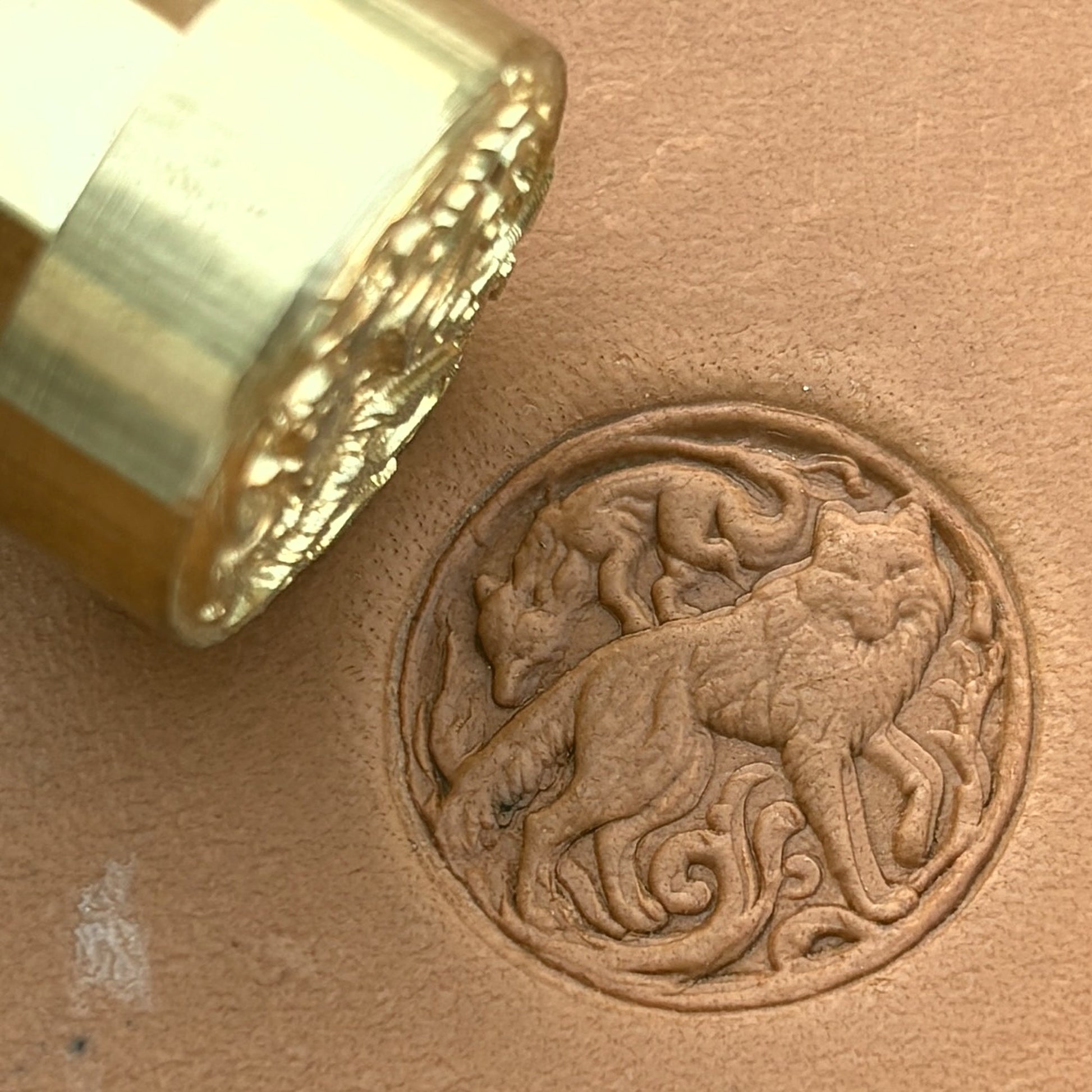 Twin Wolves Circle leather stamp LT645 — brass stamping tool with imprint on natural veg-tan leather