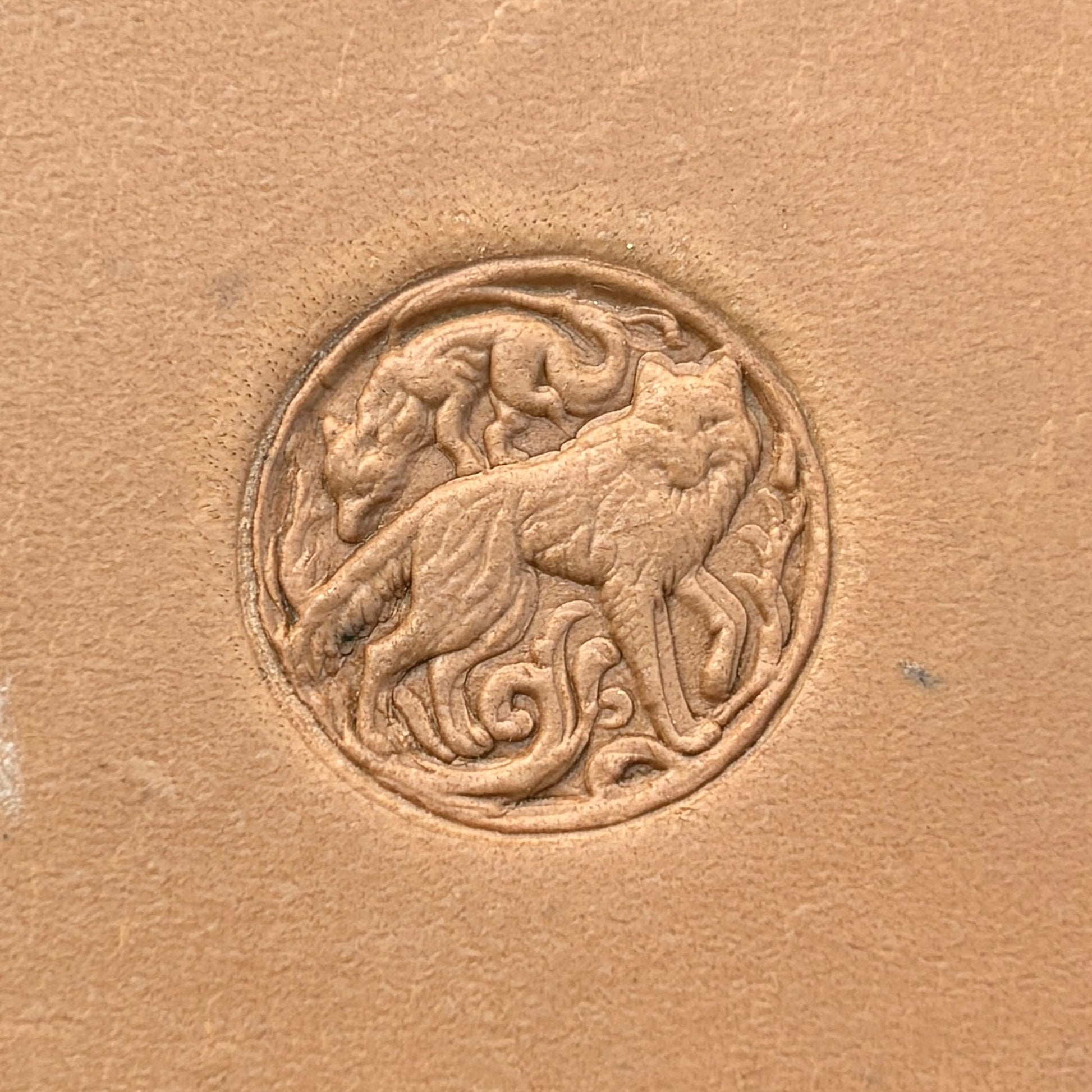 Twin Wolves Circle leather stamp LT645 — single impression on veg-tan leather
