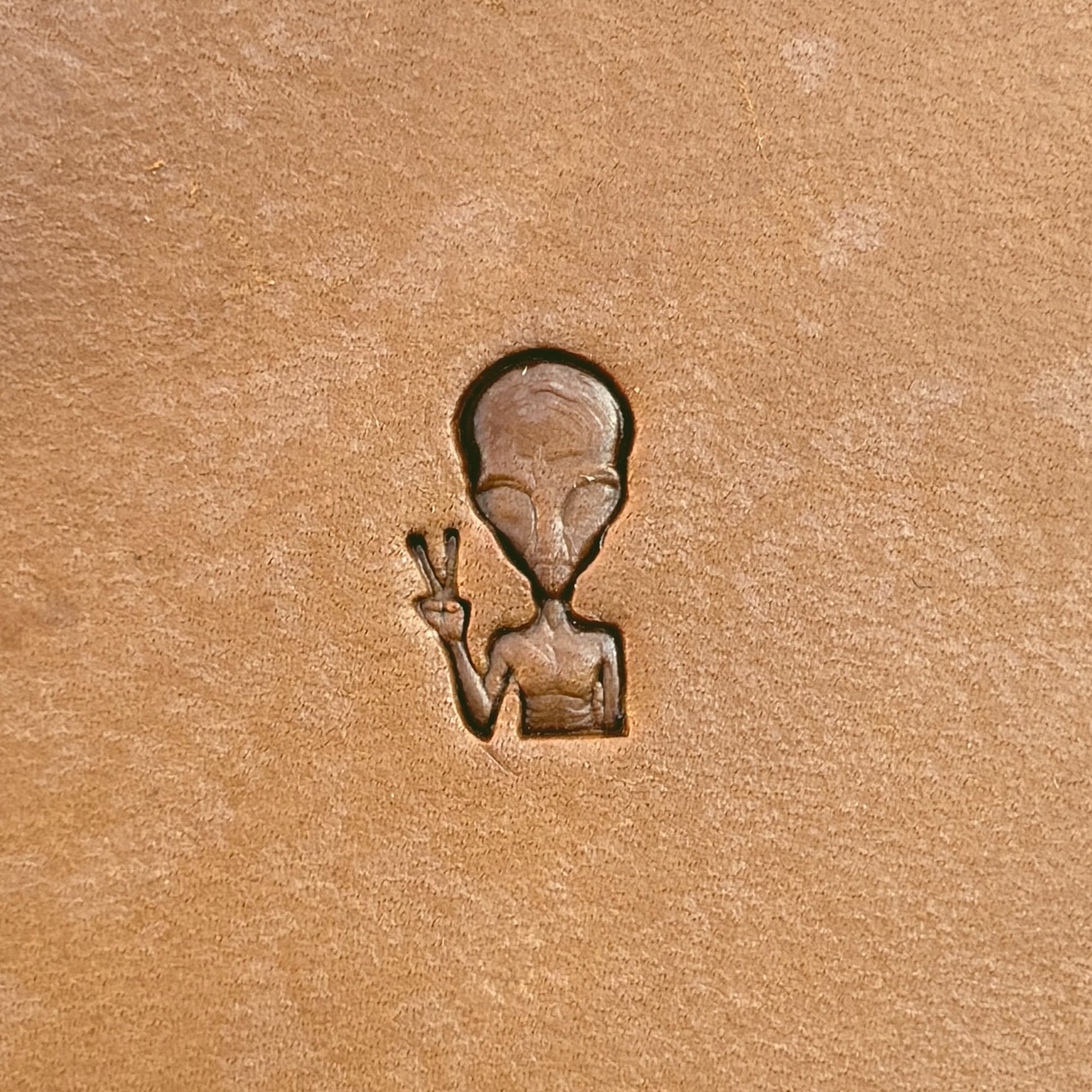 Peace Alien leather stamp LT676 — single impression on veg-tan leather