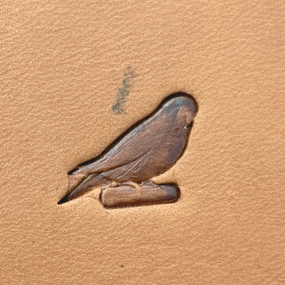 Parrot leather stamp LT687 — single impression on veg-tan leather