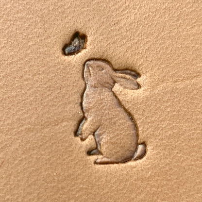 Sitting Rabbit leather stamp LT690 — single impression on veg-tan leather