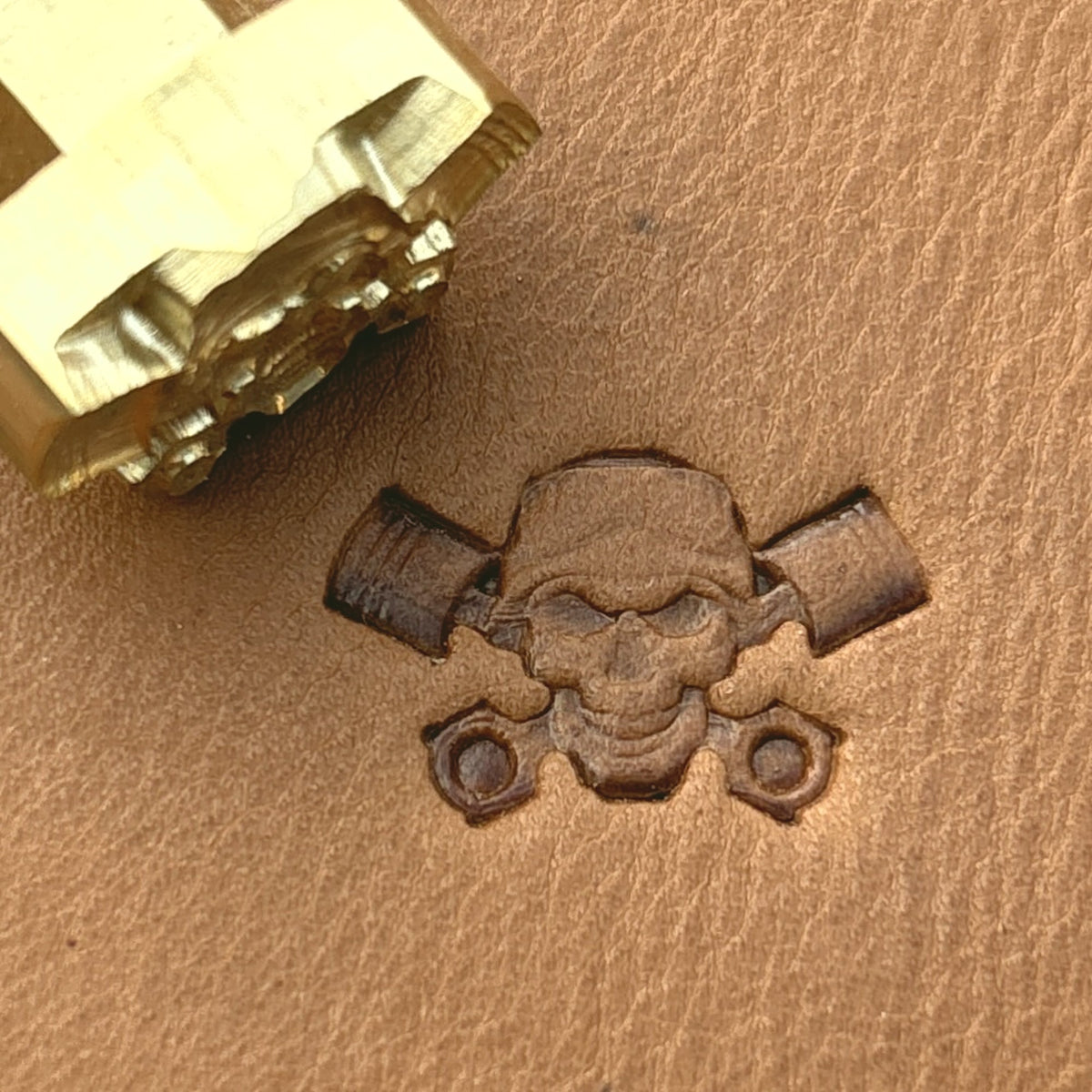 Piston Crossbones Skull leather stamp LT692 — brass stamping tool with imprint on natural veg-tan leather