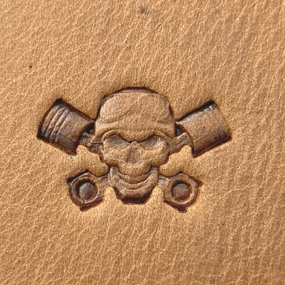 Piston Crossbones Skull leather stamp LT692 — single impression on veg-tan leather