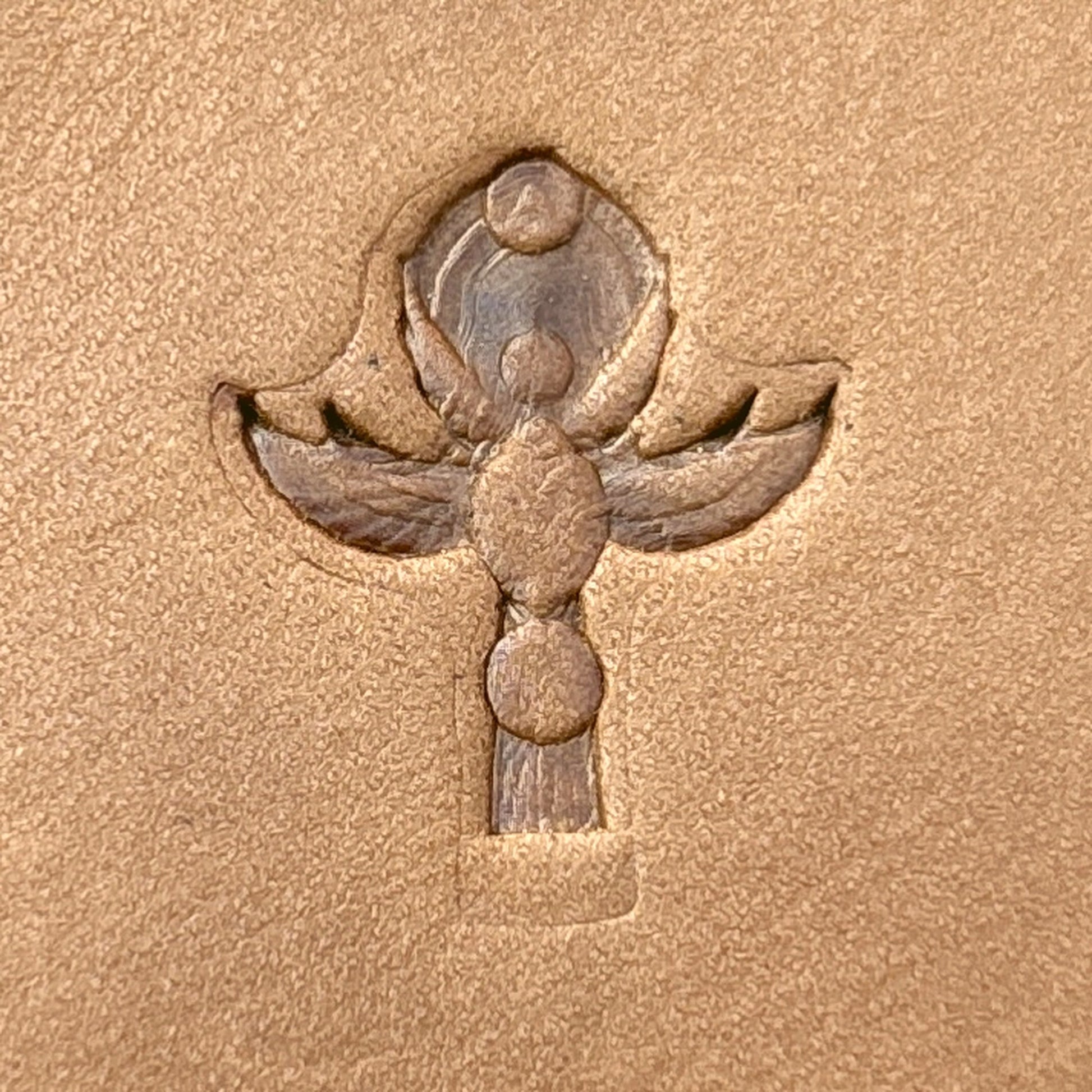 Volute leather stamp LT699 — single impression on veg-tan leather