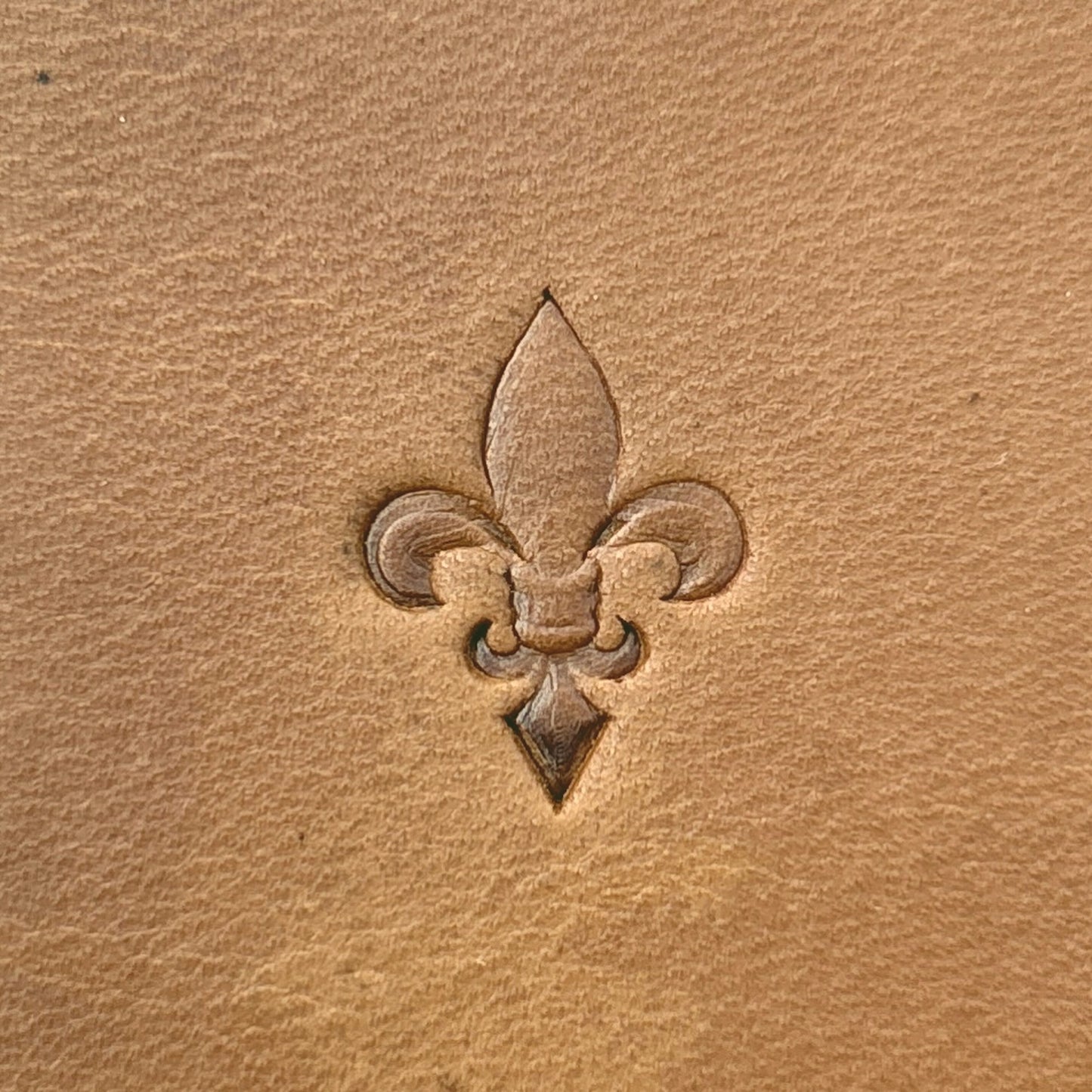 Fleur leather stamp LT704 — single impression on veg-tan leather