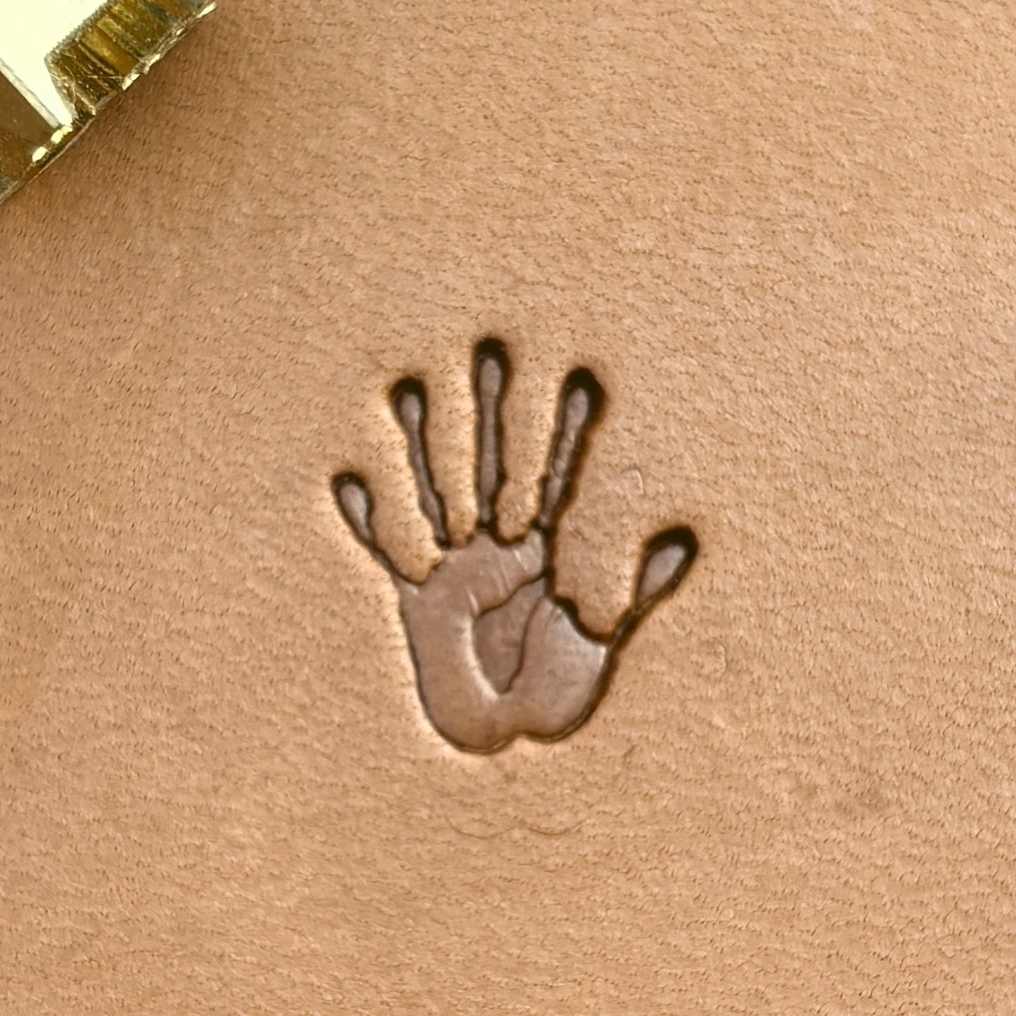Handprint leather stamp LT718 — single impression on veg-tan leather