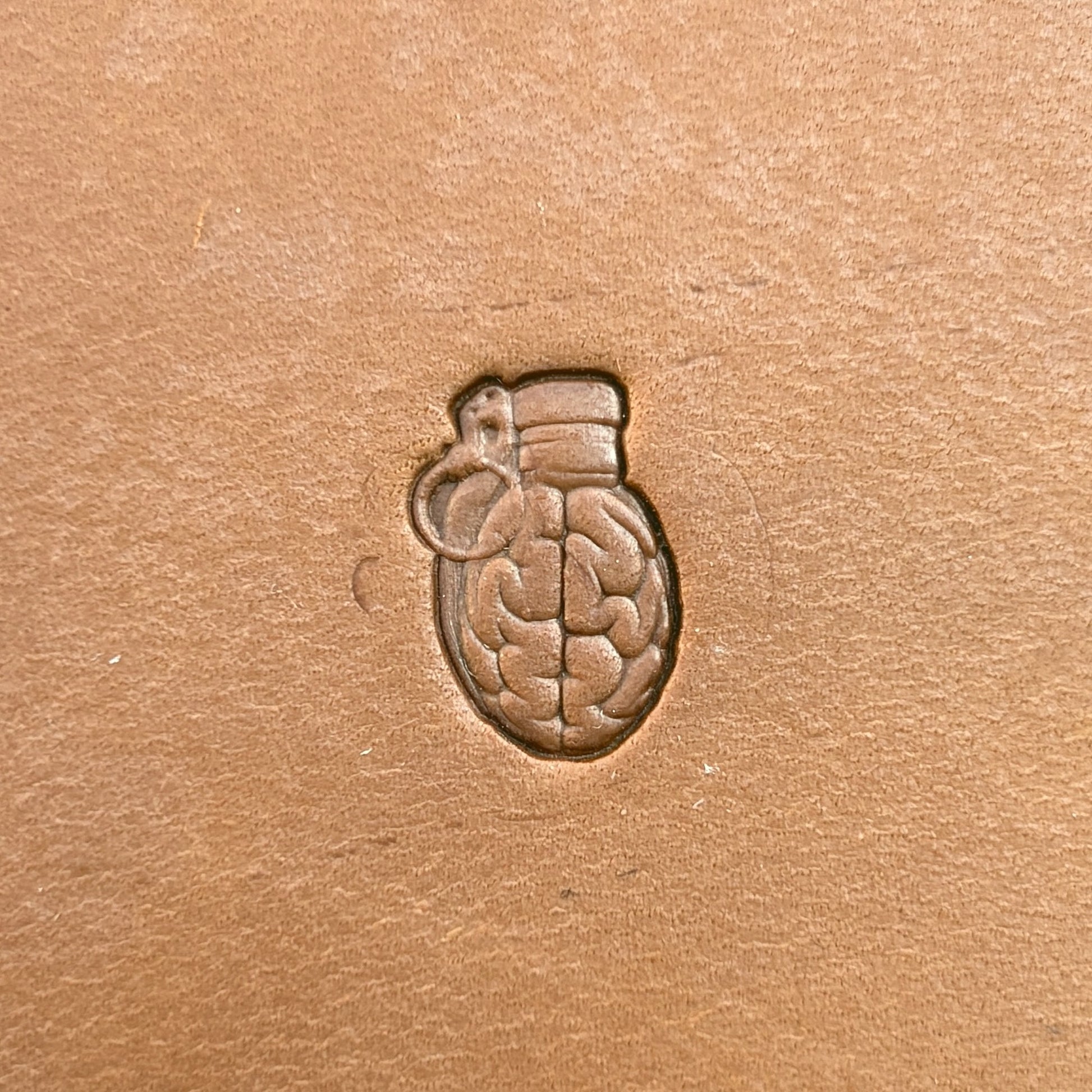 Brain Grenade leather stamp LT722 — single impression on veg-tan leather