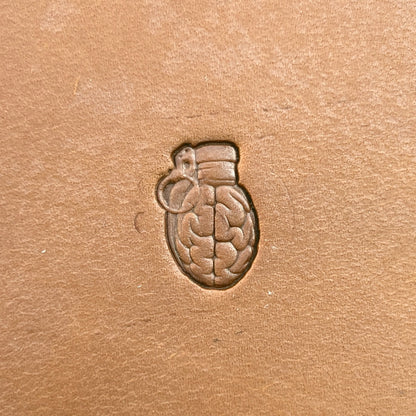 Brain Grenade leather stamp LT722 — single impression on veg-tan leather