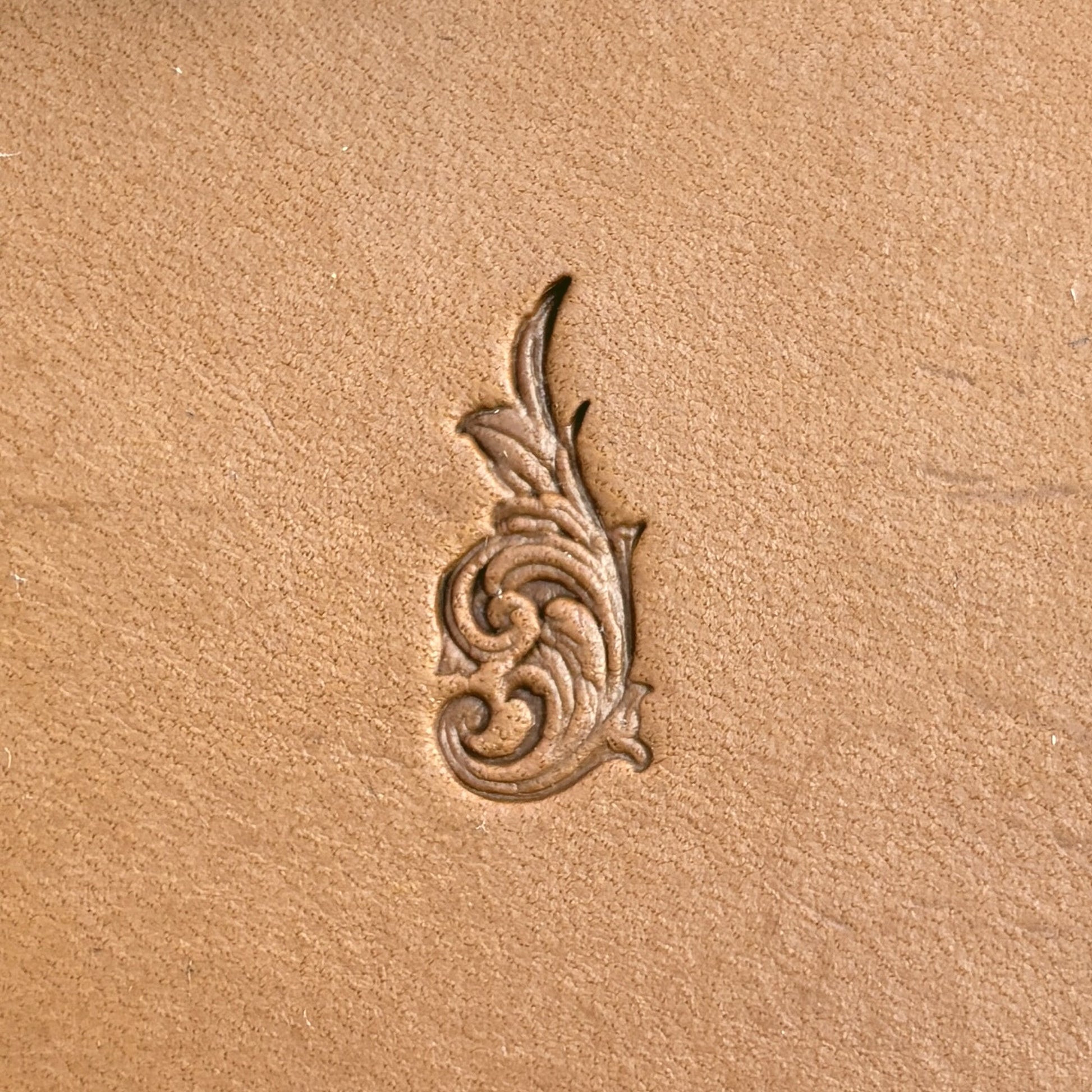 Flourish leather stamp LT724 — single impression on veg-tan leather