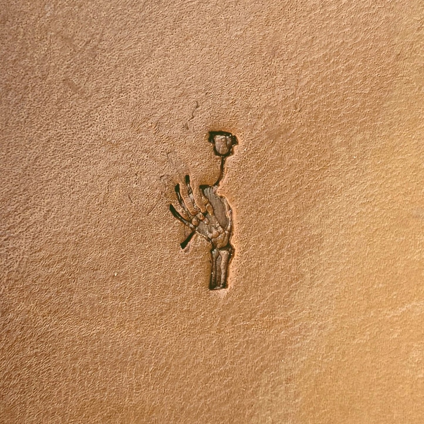 Skeleton Hand and Flower leather stamp LT726 — single impression on veg-tan leather