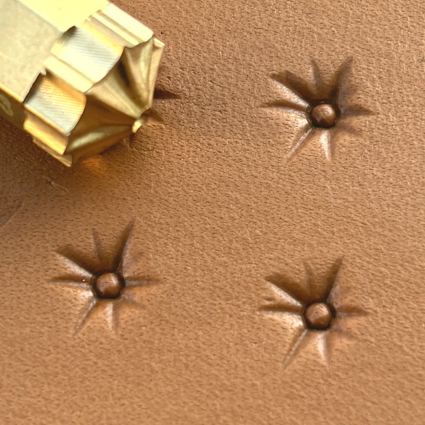 Starburst leather stamp LT743 — brass stamping tool with imprint on natural veg-tan leather