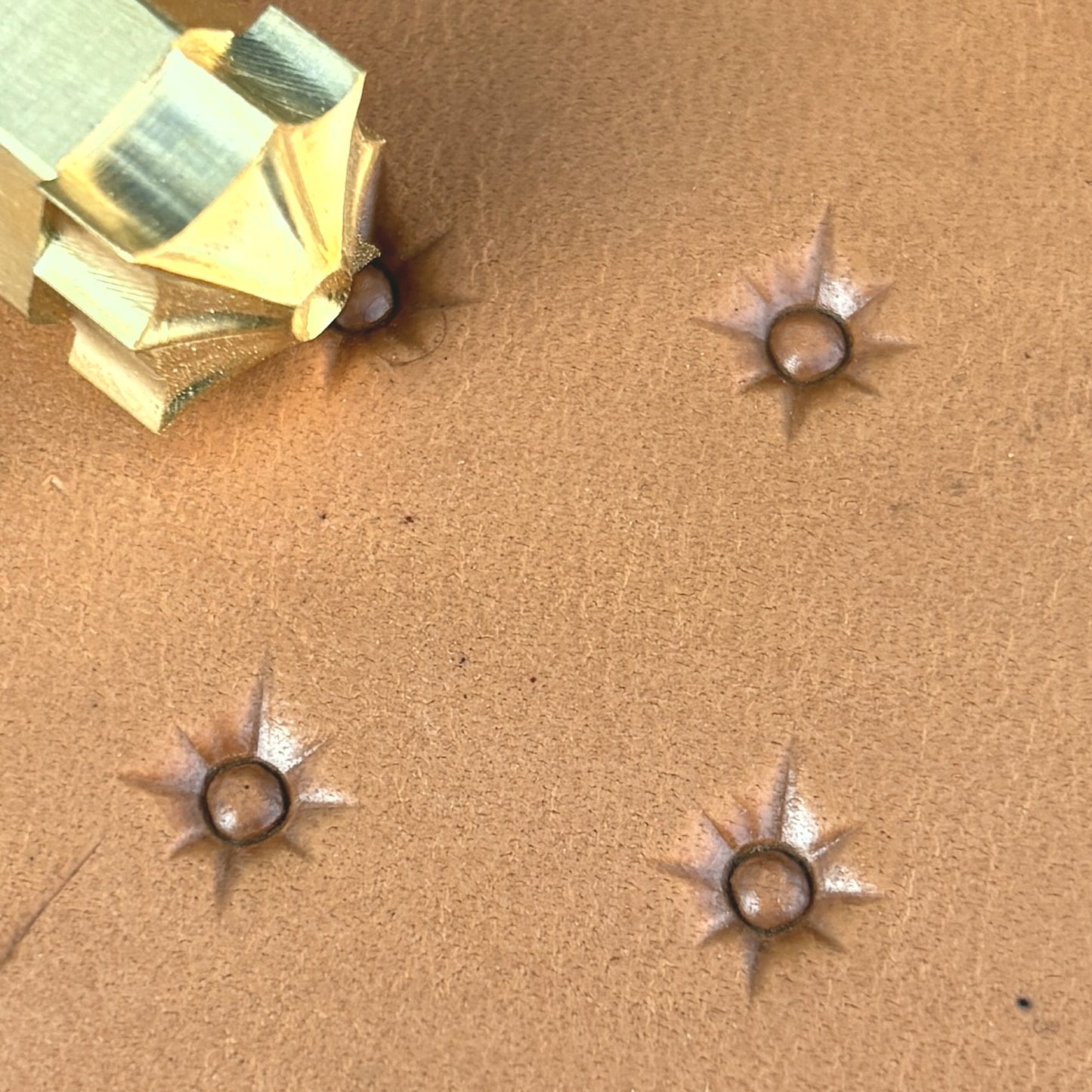 Starburst Geometric leather stamp LT749 — brass stamping tool with imprint on natural veg-tan leather