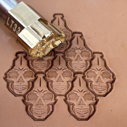 Interlocking Skulls leather stamp LT835 — brass stamping tool with imprint on natural veg-tan leather